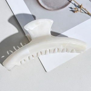 Detailed top view of a marble pattern hair claw clip on an aesthetic background