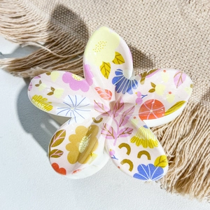 Detailed close-up of a five-petal floral hair claw clip with colorful UV printed floral patterns