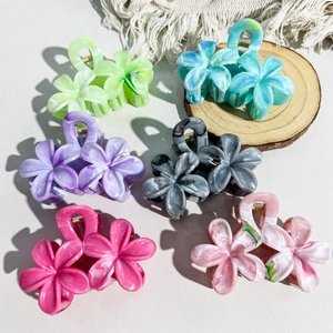 Set of six marble texture flower hair claws in multiple colors on white background