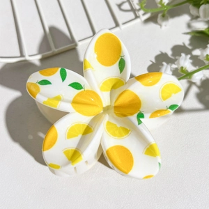 Detailed view of floral hair claw clip featuring fresh lemon print and white petals