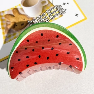Détail d'une pince à cheveux créative en forme de pastèque avec un motif de fruit d'été