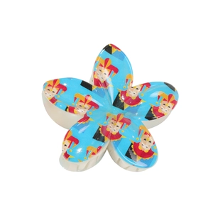 Blue plumeria flower hair claw clip with playful circus clown patterns for styling
