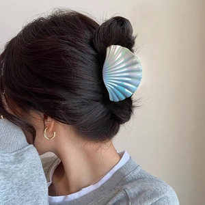 Iridescent shell-shaped hair claw clip with purple and cyan pearlescent finish