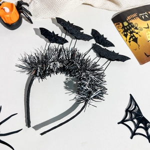 Close-up of Halloween headband with black bats on springs and festive props