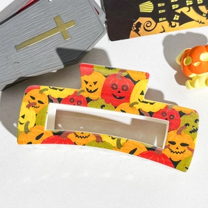 Detail of Halloween pumpkin pattern on square hollow hair claw clip with festive props