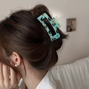 Light blue Halloween 8.5cm square hair claw clip with pumpkin and bat prints on hair