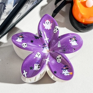 Detail of purple flower Halloween hair claw clip with ghost and spider web prints