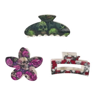 Gothic Halloween hair claw set with skull and rose patterns on a white background