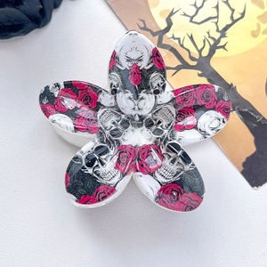Detail of gothic five-petal flower hair claw clip with skull and red rose prints