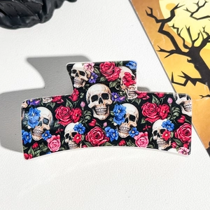 Detail of Halloween hair claw clip featuring gothic skull and red rose prints