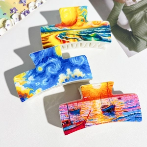 Detailed close-up of Van Gogh oil painting style hair claws made of glossy acetate material