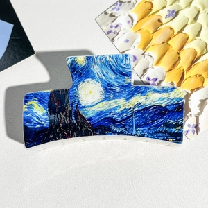 Detailed view of Van Gogh Starry Night print hair claw clip on textured background