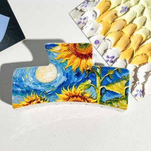 Detail of Van Gogh oil painting hair claw clip with sunflower and starry night patterns
