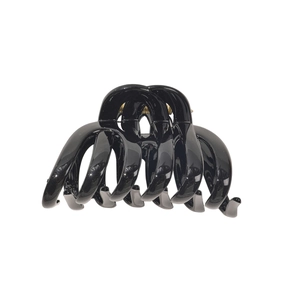 Glossy black large fence hair claw clip with golden metal spring on white background