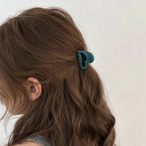 Morandi dark green matte heart hair claw clip shown on a model for half-up hairstyles