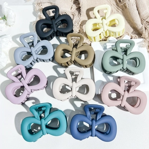 Detailed macro view of 10-piece matte Morandi bow hair clips in assorted pastel colors