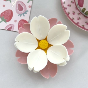 Macro close-up of 3D cherry blossom fridge magnet with matte pink and white resin petals