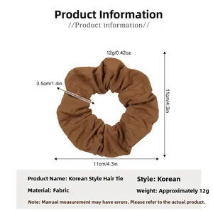 Detailed dimensions of brown fabric scrunchie with 11cm outer diameter and soft texture