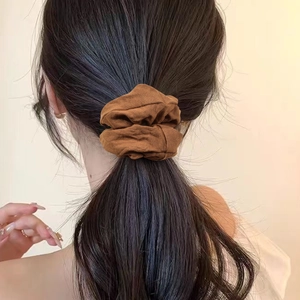 French style brown knitted scrunchie hair tie shown on a simple minimalist ponytail