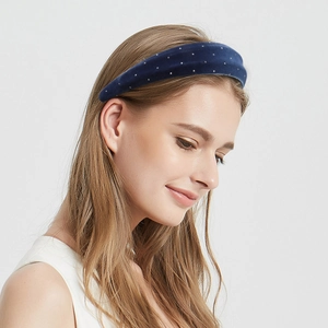 Fashionable navy blue suede headband with silver rhinestones on a model for hair styling