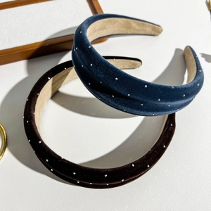 Detail of suede headbands with sparkling rhinestones in navy blue and brown colors