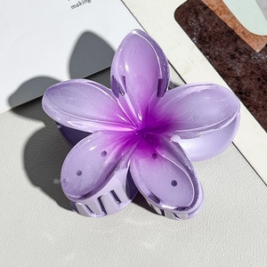 Detailed macro of a purple gradient plumeria hair claw clip with matte acrylic finish