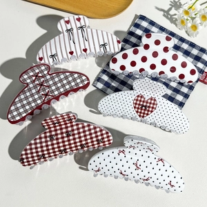 Close-up of retro checkerboard hair claws with sturdy teeth and varied patterns