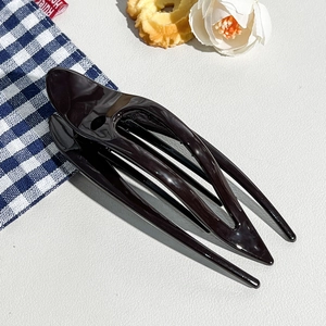 Close-up of black glossy leopard-style hair claw with sleek streamlined hollow structure