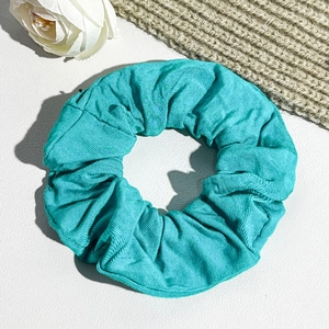 Detail of teal ribbed fabric scrunchie texture for elegant French style hairstyles