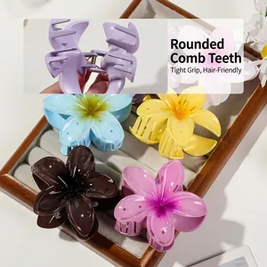 Frangipani flower hair claws in multiple colors including blue, yellow, and pink purple