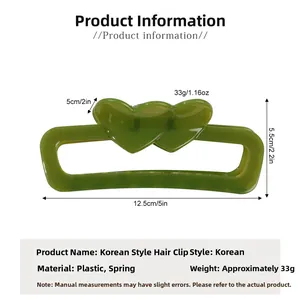 Macro view of green double-heart hair claw clip with dimensions 12.5cm by 5.5cm