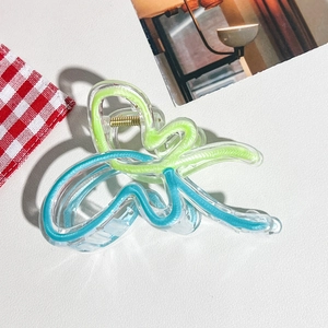 Gros plan sur la pince à cheveux papillon dégradé bleu et vert en résine claire