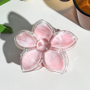 Detail shot of marble textured flower hair claw clip with pink resin and silver glitter