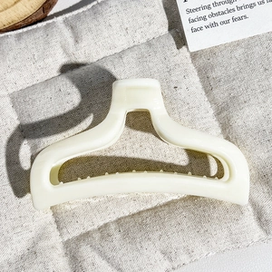 Close-up of cream fishtail hair claw clip showing smooth texture and non-slip teeth