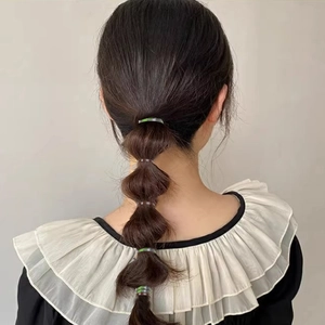 Elastic hair ties for bubble braid hairstyle on a female model with long dark hair