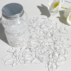 Transparent elastic hair ties in a clear storage jar with a silver screw cap