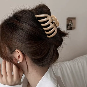 Beige pumpkin shark hair claw clip for thick hair shown on model in a sleek updo style