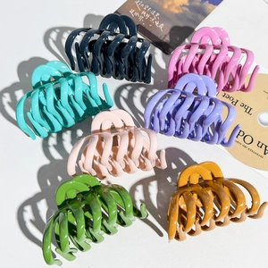 Detailed top view of large colorful matte silicone shark hair clips for thick hair