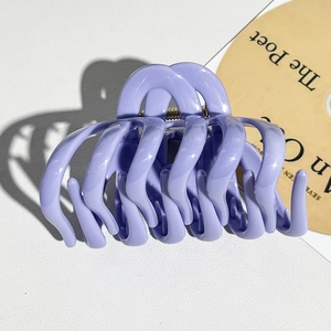 Detail view of large lavender pumpkin hair claw with wave structure and metal spring