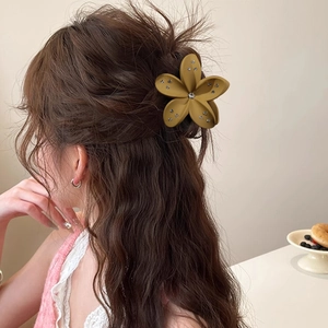 8cm yellow floral hair claw with sparkling rhinestones worn on a half-up hairstyle