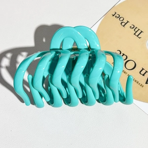 Detail of Tiffany blue soft silicone pumpkin hair claw clip showing smooth finish and teeth