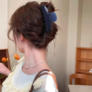 Navy blue polka dot hair claw clip for elegant updo styling on long brown hair