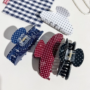 Close-up of four-piece set polka dot hair claws in white navy burgundy and black