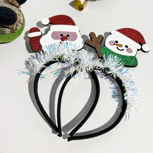 Close-up of Santa Claus and Snowman headband set with glitter and tinsel decorations