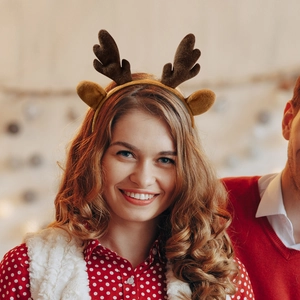 Close-up of cute brown reindeer antler headband with soft plush ears for Christmas party