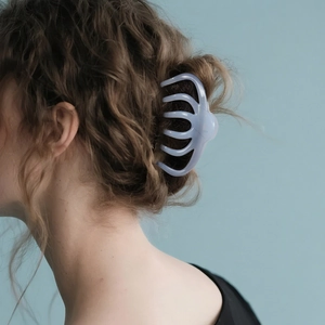 Élégante grande pince à cheveux bleu clair pour femmes montrée dans une coiffure stylée