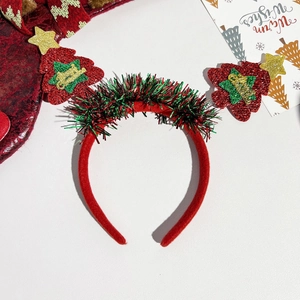 Detail of red Christmas tree headband with golden Merry Christmas text and sequins