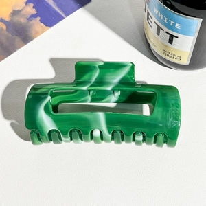 Macro shot of green marble pattern hair claw clip with rectangle hollow design