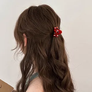 Red Christmas wave hair claw with snow pattern and colorful dots on brown hair