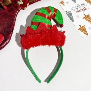 Detail of Christmas elf hat headband with red stripe pattern and jingle bell accent